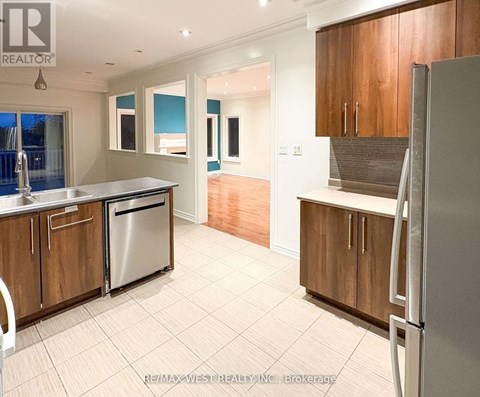 A kitchen with wooden cabinets and a refrigerator.