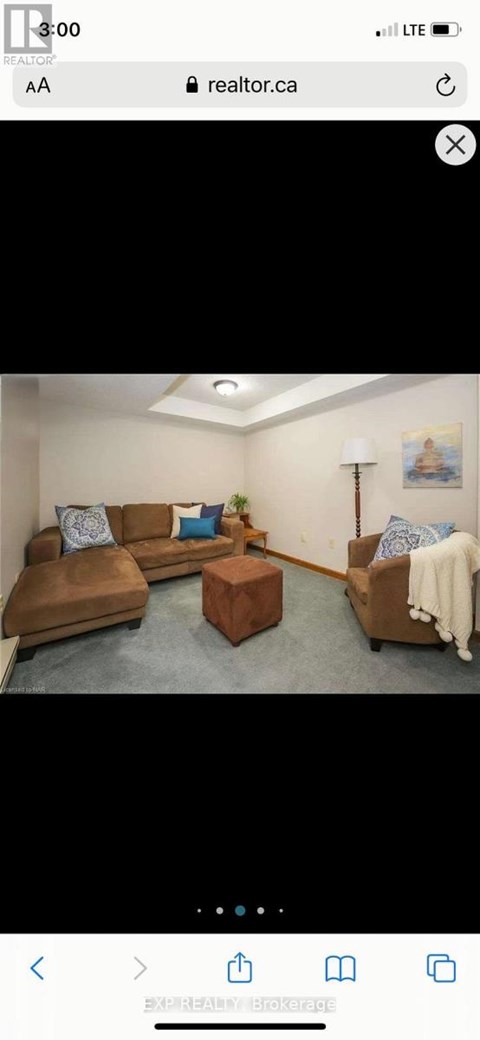 A living room with a brown leather sofa and a wooden coffee table.