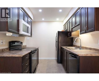 A kitchen with brown cabinets and a granite counter top.