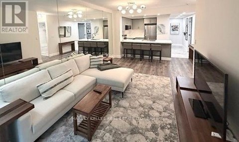 A living room with a white couch and a television.