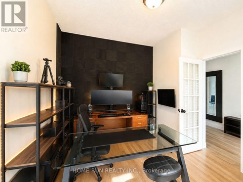 A modern living room with a glass table and a television.