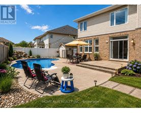A real estate photo of a house with a pool and a patio.