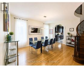 A dining room with a glass table and chairs.