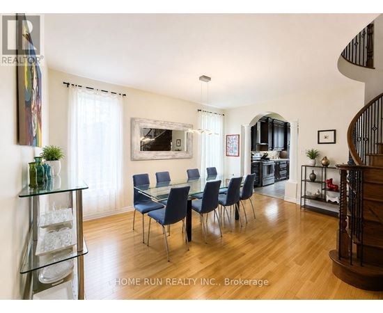 A dining room with a glass table and chairs.