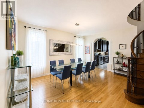 A dining room with a glass table and chairs.