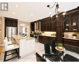 A modern kitchen with dark brown cabinets and a marble island.