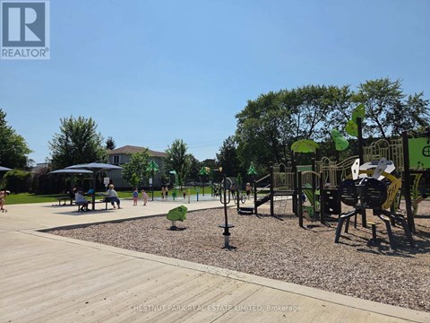 A playground with a slide, swings, and a seesaw.