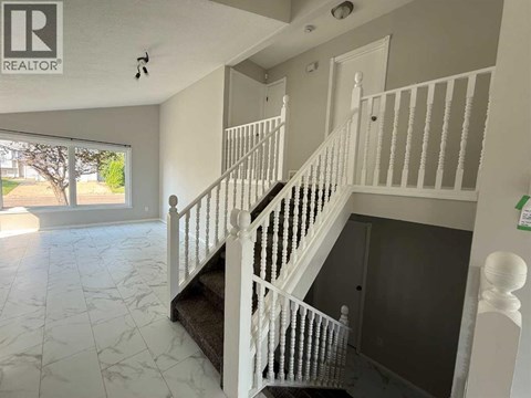 A white staircase with a marble floor.