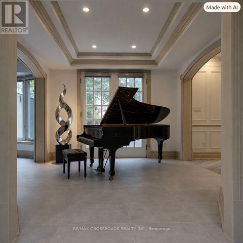 A grand piano sits in a spacious room with a large sculpture beside it.