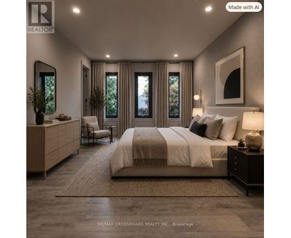 A well-lit bedroom with a large bed, a chair, and a side table.