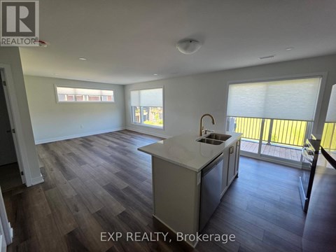 A kitchen with a sink and a window.