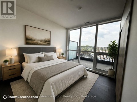 A well-lit bedroom with a large bed and a view of the outside through the glass doors.