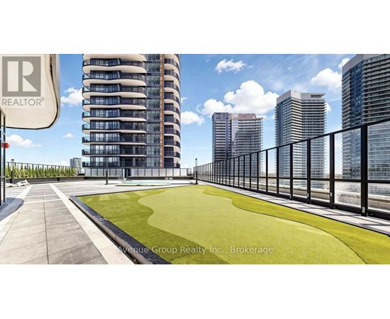 A modern building with a green lawn in front of it.