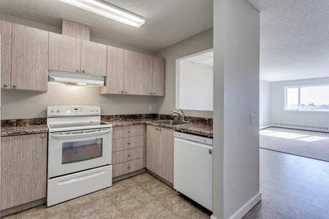 A kitchen with a white oven and a white dishwasher.