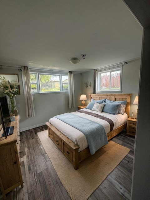 A bedroom with a large bed and a television.