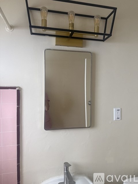 A bathroom with a sink and a mirror.