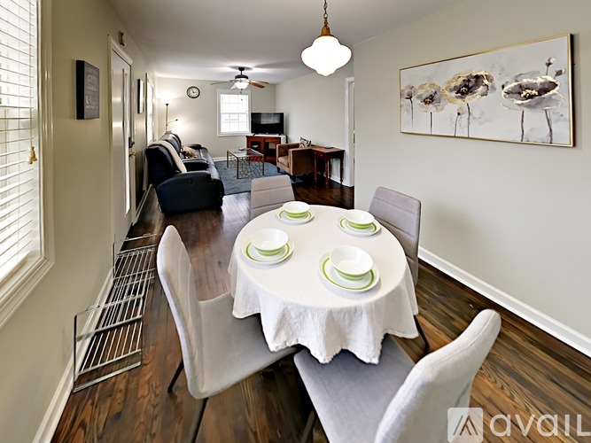 A dining room with a white table set for four.