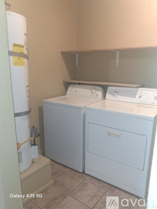 A small laundry room with a washer and dryer.