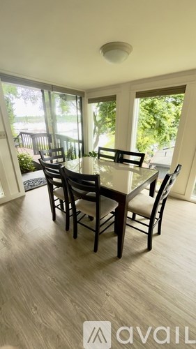 A dining room with a table and chairs is available for rent.