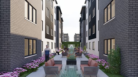 A modern courtyard with a fountain and seating area surrounded by brick buildings.