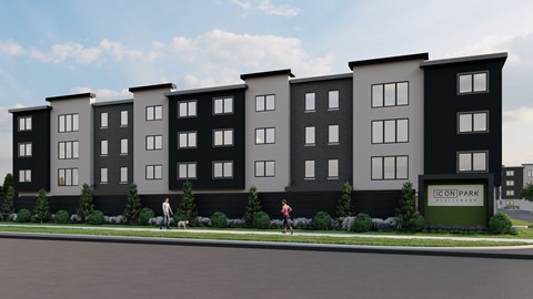 A row of modern townhouses with a woman walking a dog in front.