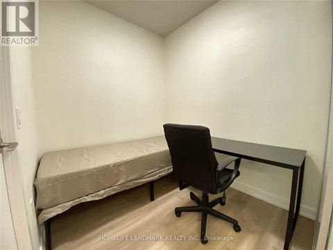 A room with a bed and a desk.