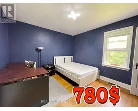 A bedroom with a bed, desk, and window is on sale for 780 dollars.