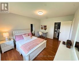 A bedroom with a large bed and a small table.