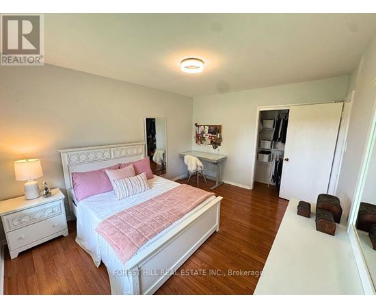 A bedroom with a large bed and a small table.