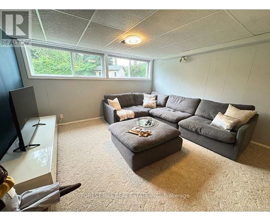 A living room with a grey couch and a coffee table.