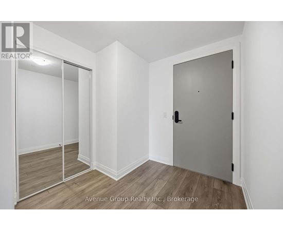 A brokerage office with a white door and a glass wall.