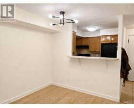 A room with a ceiling fan and a counter with a microwave.