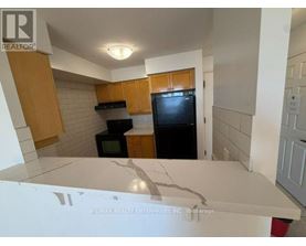 A bathroom with a tub, toilet, and sink.