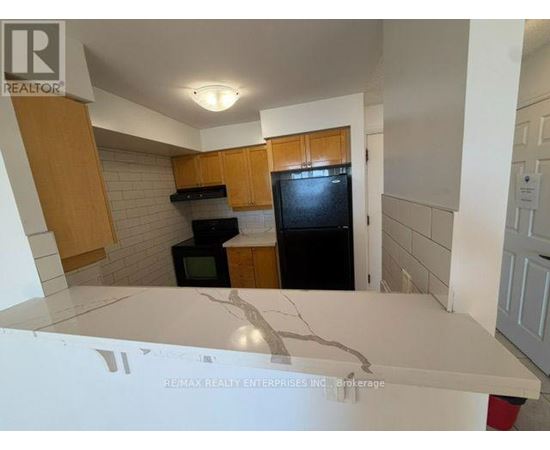 A bathroom with a tub, toilet, and sink.