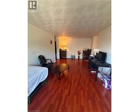 A living room with a wooden floor and a white ceiling.