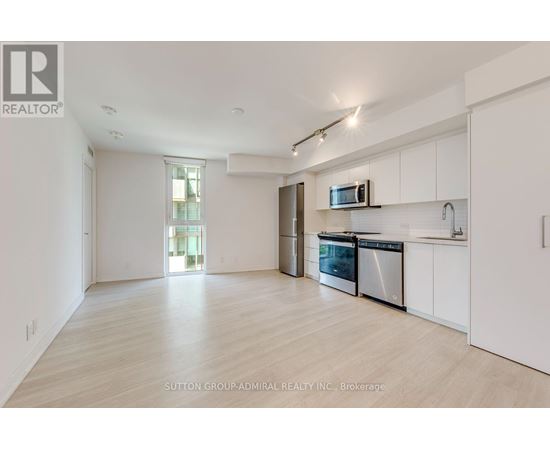 A spacious kitchen with white cabinets and stainless steel appliances.