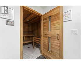 A room with a wooden door and a bench inside.
