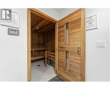 A room with a wooden door and a bench inside.
