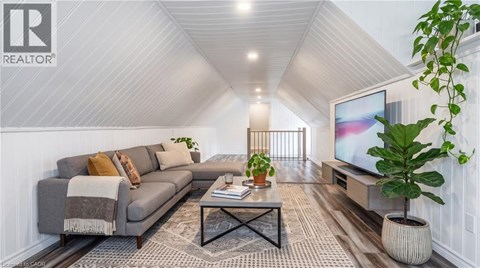 A living room with a grey sofa, a coffee table, and a television.
