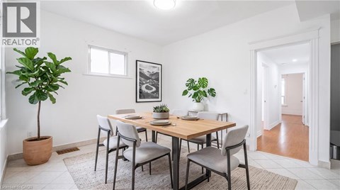 A dining room with a table and chairs.