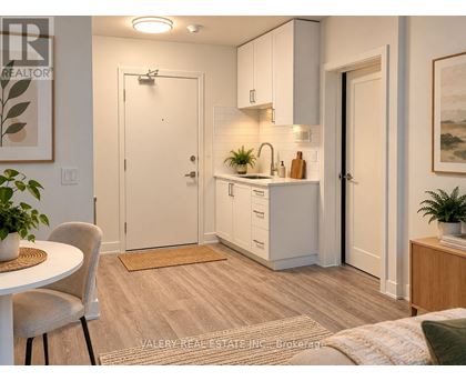 A kitchen with white cabinets and a sink.