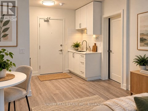 A kitchen with white cabinets and a sink.
