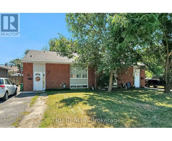 A house with a white door and a tree in front of it.