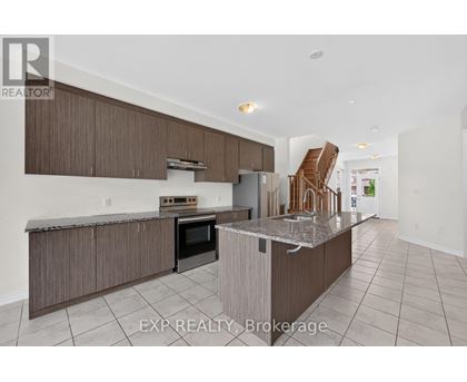 A kitchen with a stove top oven and a refrigerator.