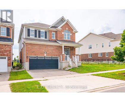 A house with a brick facade and a garage door is for sale.