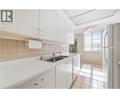 A kitchen with white cabinets and a sink.