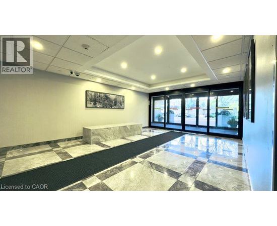 A realtor office with a marble floor and a framed picture on the wall.