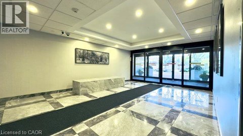 A realtor office with a marble floor and a framed picture on the wall.