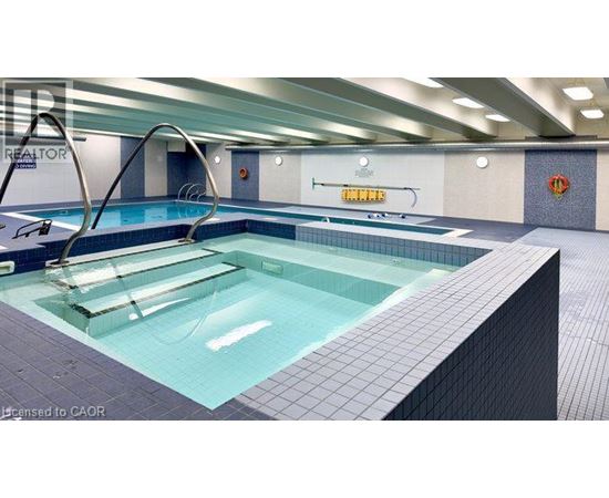 A swimming pool in a well lit indoor swimming pool.
