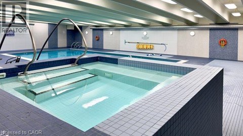 A swimming pool in a well lit indoor swimming pool.